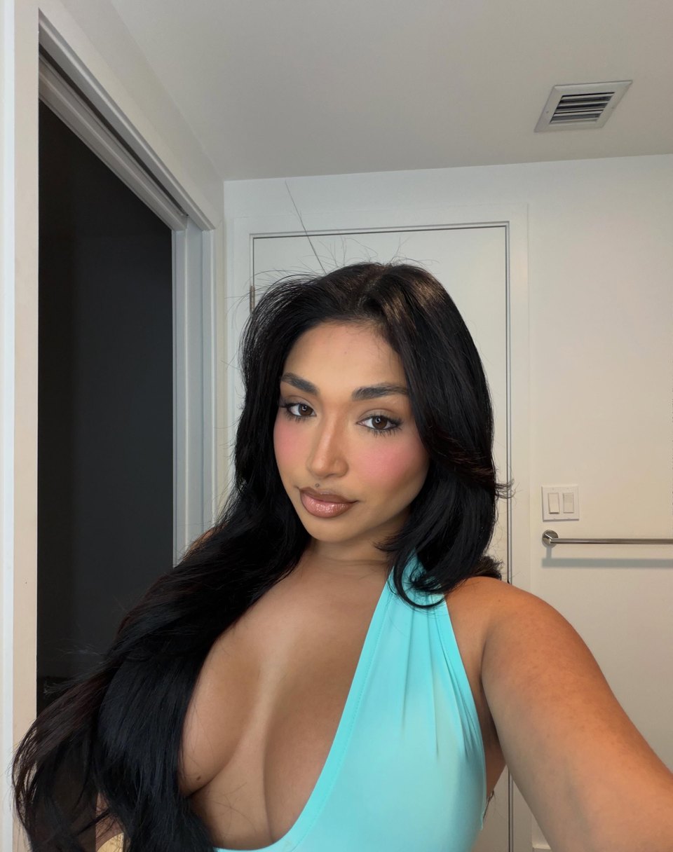 Close portrait of Ale Jade in an aqua halter look.
